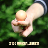 Person balancing a brown egg on their index finger, with text reading "X 100 FUN CHALLENGES!".