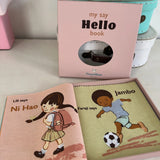 "my say Hello book" open fabric rag book inside its pink gift box on a white table.