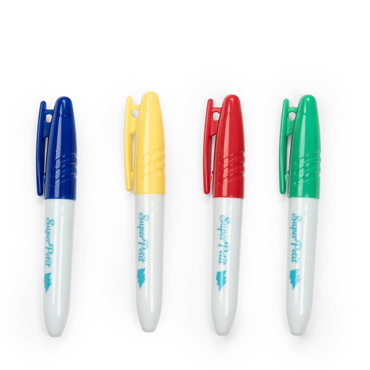Four colorful plastic markers are aligned horizontally on a white background. The caps are blue, yellow, red, and green, conveying a vibrant tone.