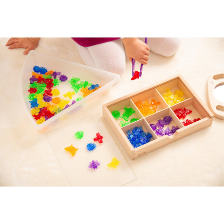 A set of colorful, see-through plastic bug figures designed for sensory play, sorting, counting, and light table exploration.