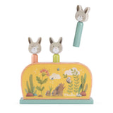 Moulin Roty Trois Petits Lapins wooden pop up toy with three jumping rabbits.
