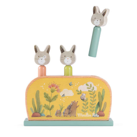 Moulin Roty Trois Petits Lapins wooden pop up toy with three jumping rabbits.