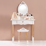 White wooden toy vanity table and stool set up with play beauty accessories and a storage bag.