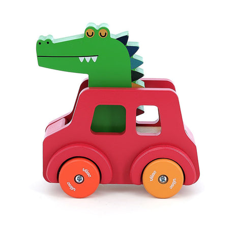 Vilac wooden crocodile beep car toy with a red body and orange wheels, side view on white background.
