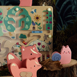 Wooden garden magnetic maze toy with pink wooden animals on a tree stump.