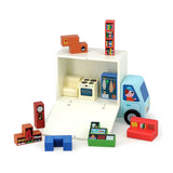 Wooden moving truck toy with Tetris-like furniture blocks including a stove, couch, and bookcase.
