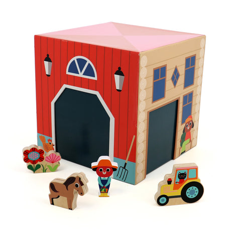 Wooden farm house toy with a farmer, horse, tractor, and flowers on a white background.