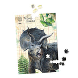 Vilac Triceratops dinosaur jigsaw puzzle, partially completed with loose pieces on a white background.