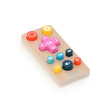 Vilac wooden toy remote control with colorful buttons isolated on a white background.
