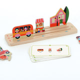 Vilac wooden educational game showing a toy bus, flower shop, and house placed on a slotted base with cards.