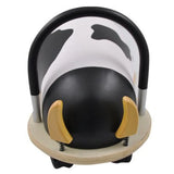 Front view of the cow Wheely Bug ride-on toy, showing its wooden horns on springs, black-and-white pattern, and handle.