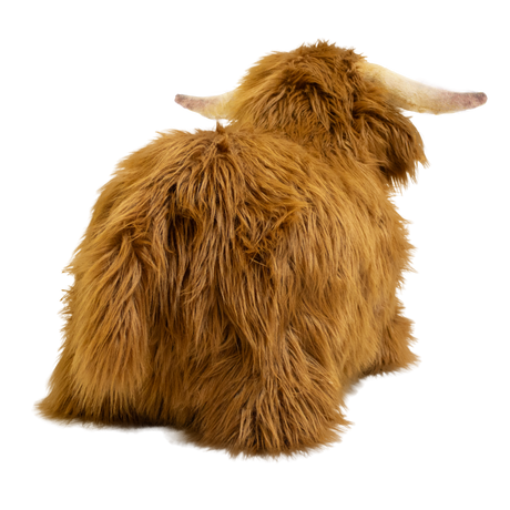 Fluffy brown plush toy resembling a Highland cow, with long fur and curved horns, set against a white background, conveying a cozy and whimsical feel.