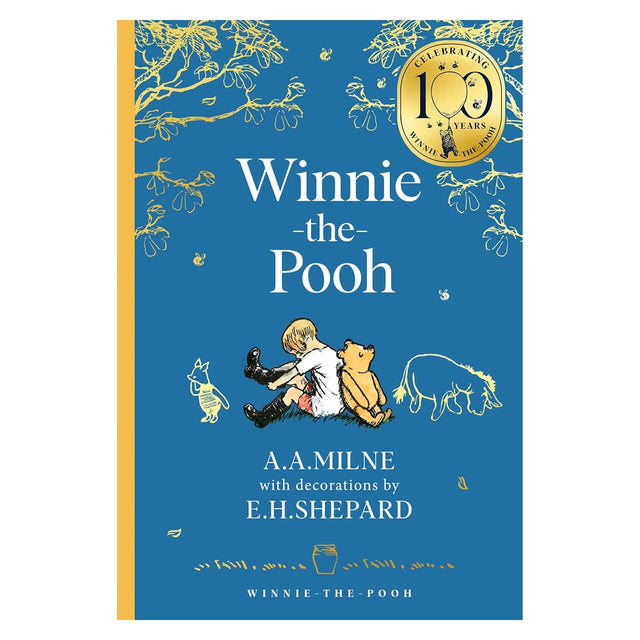 Winnie-the-Pooh 100th anniversary book cover by A.A. Milne and E.H. Shepard with Christopher Robin and Piglet on blue.