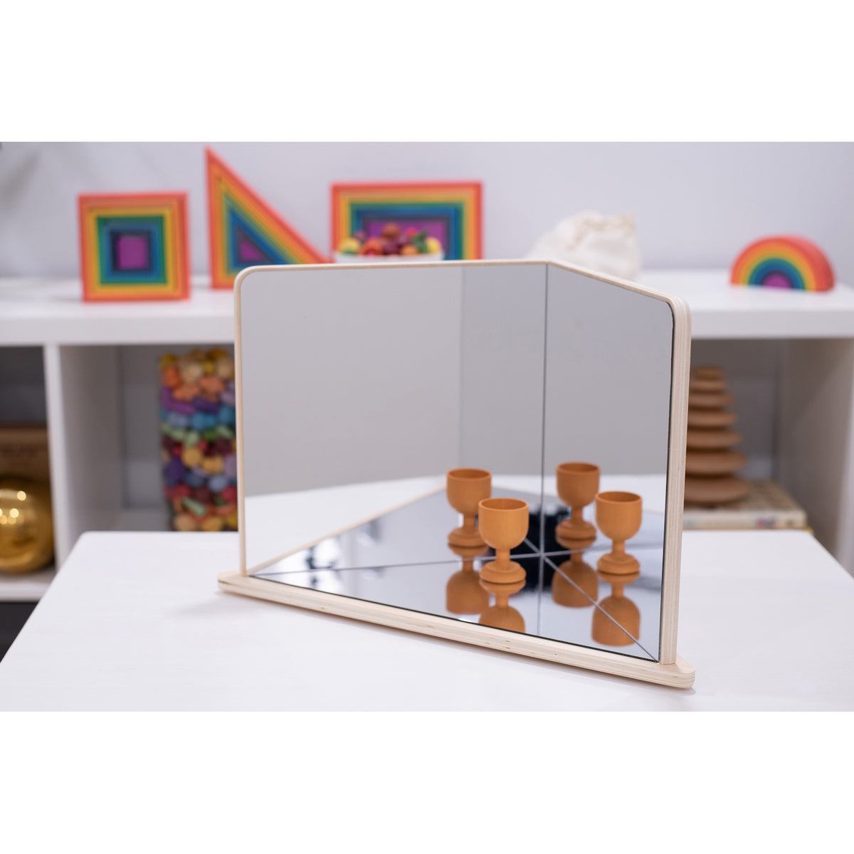 A wooden-framed mirror with four reflective panels arranged to create kaleidoscopic visual effects, ideal for sensory exploration and light play.