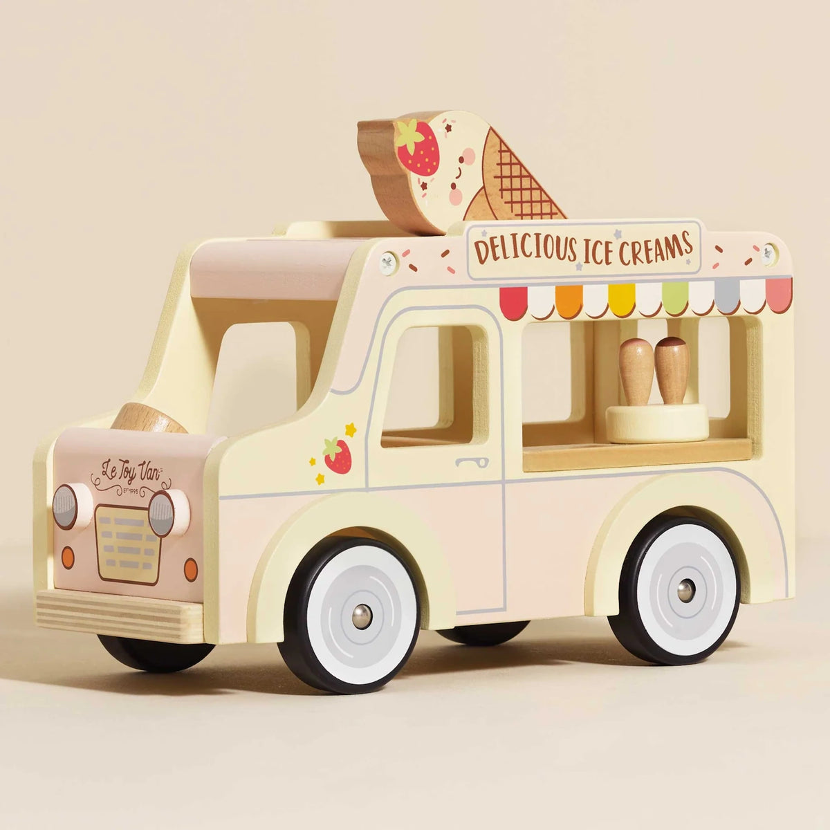 A pastel yellow and pink wooden toy ice cream van with a large ice cream cone on the roof.