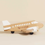 Natural wooden toy airplane with white painted accents and propellers.